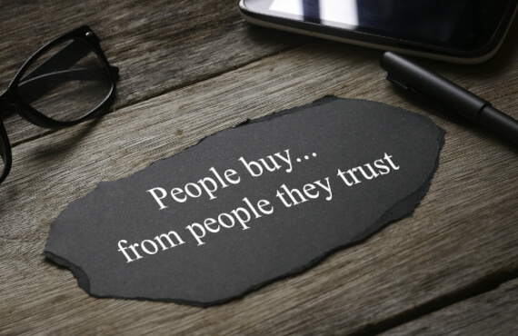 People Buy From People They Trust Paper on Desk
